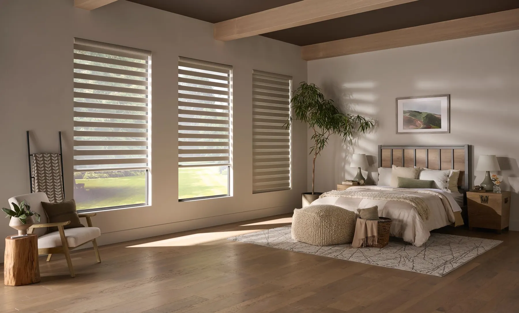 Light banded shades on three windows of a calm bedroom with wood floors and a low wood bed.